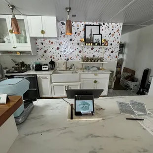a kitchen counter with a laptop on it