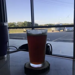 a glass of beer on a table
