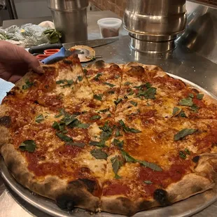 a person cutting a pizza