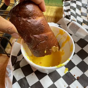 Pretzel with cheese sauce
