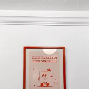 a red framed poster of a cat