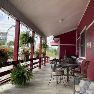 a porch with tables and chairs