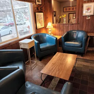 a living room with blue leather chairs