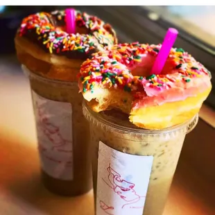 two iced donuts with sprinkles