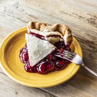 a piece of pie on a yellow plate