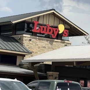 cars parked in front of a restaurant