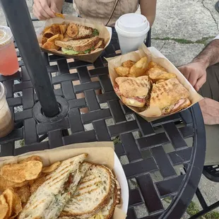 Fried green tomato BLt, muffaletta, and a turkey pesto sandwich all served with homemade chips