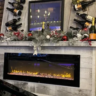 a fireplace with wine bottles on it