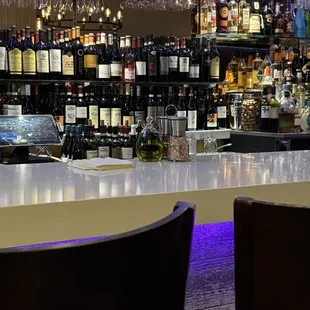 a bar with wine glasses hanging from the ceiling