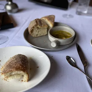 a plate of bread and a bowl of olive oil