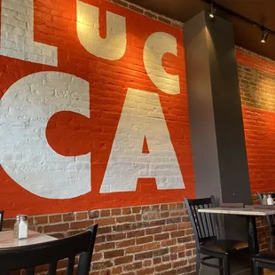 a red brick wall with white lettering