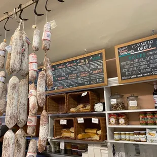 a variety of sausages hanging from hooks