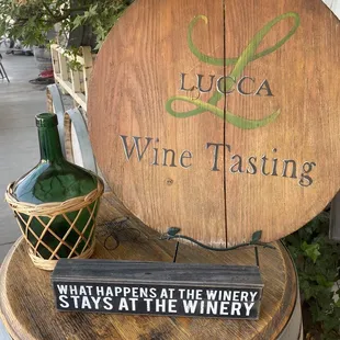 a wine tasting sign on a barrel
