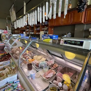 Meat counter with hanging salamis