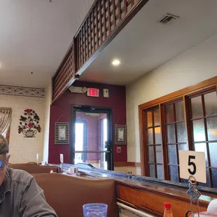 The front dining area has a few booths and tables.
