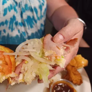 a woman holding a sandwich