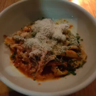 Papparadelle pasta with braised tomato rabbit sauce.