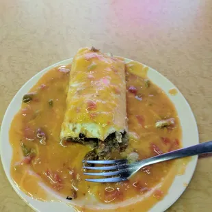 Egg, potato, and sausage burrito smothered. $6