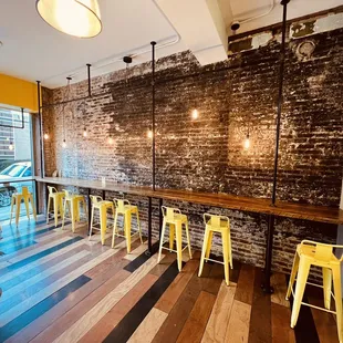 a bar with yellow stools