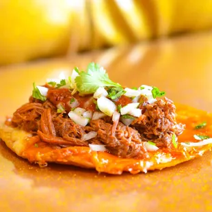 Try our Birria Quesa Taco! Pick beef or vegan birria with melted jack cheese, onions-cilantro mix, and spicy Salsa Muerta on a corn tortila