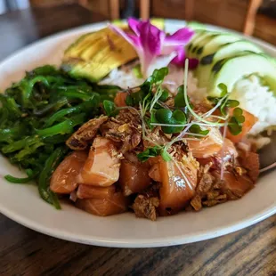 Salmon Poke. $18.99. Raw salmon with sesame, onion, and tamari with seaweed salad, rice, and avocado.