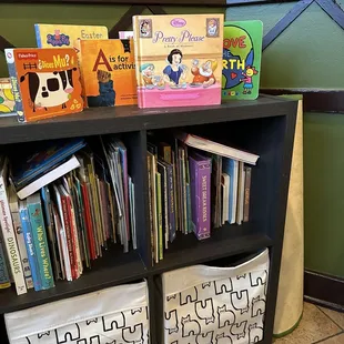 a bookshelf with a variety of children's books