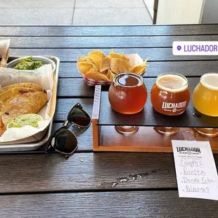 Carne asada fries, taco de asada, guacamole, tacos gobernador and a flight of delicious Beer!