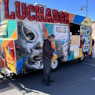 a man standing in front of a food truck