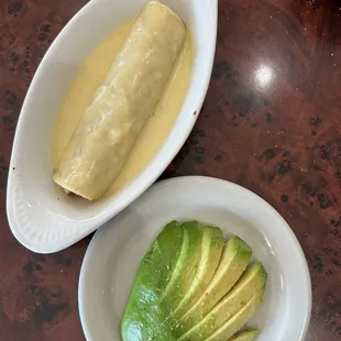 Enchiladas Blancas (a la carte) w/ a side of sliced avocado