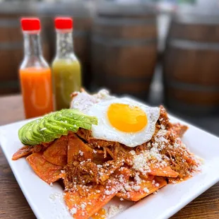 1/2 Order Chilaquiles ($8.50) w/ cochinita pibil, Yucatán roasted pork ($3.25), avocado ($3)