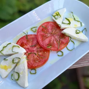Fresh mozzarella, tomato, olive oil + basil (July 2022 menu)