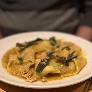 Cappellacci with sage, browned butter, and amaretto cookies.