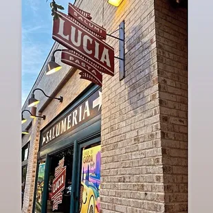 a brick building with a sign that says lucia