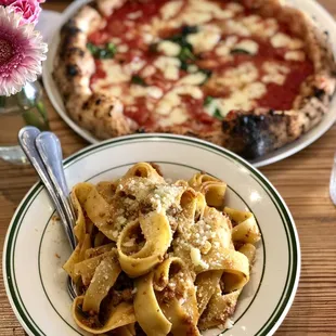 a plate of pasta and a pizza