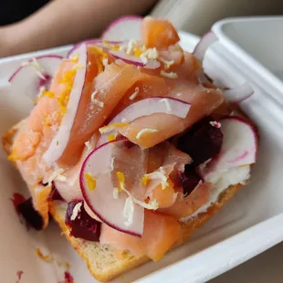 Salmon toast with beets, orange zest, and grated horseradish