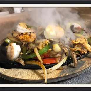 Delicious Texas Fajitas (steak, shrimp &amp; chicken) loaded with veggies.
