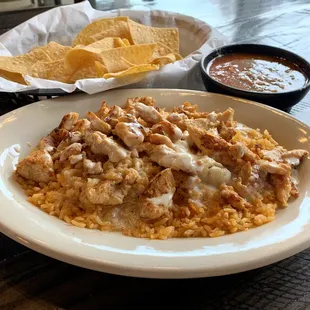 Mexican comfort food, Arroz con Pollo made with grilled chicken tenders, served over rice and topped with our delicious queso.