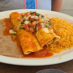 Shrimp Enchiladas served with rice and beans.