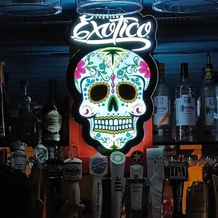 a neon sign of a sugar skull