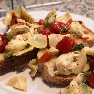 a plate of artichokes and tomatoes