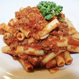 a plate of pasta with sauce and parsley