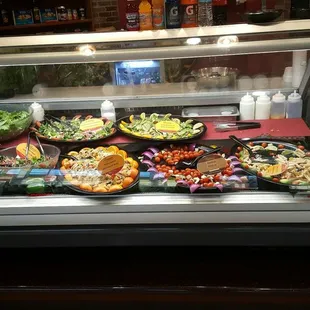 a display case with a variety of food items