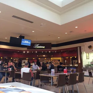 people sitting at tables in a restaurant
