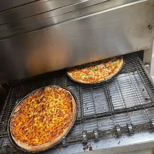 two pizzas on a grill