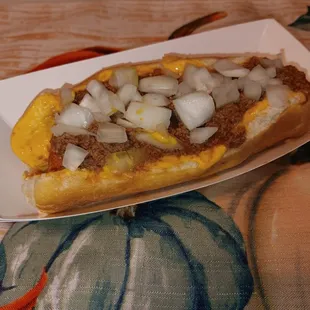 Southside Dog 100% Vienna Beef, Queso Cheese, Homemade Chili Sauce, and Fresh Chopped Onion.