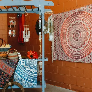 Outdoor tapestry display with fair trade wind chimes.
