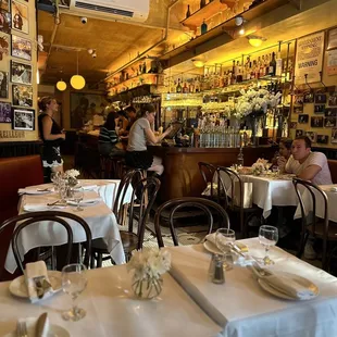 the interior of a restaurant with tables and chairs