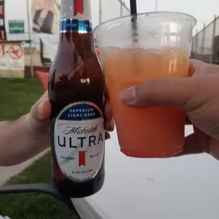 a person holding a glass of beer