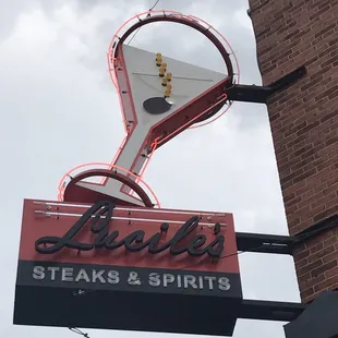 a neon sign for a steak and spirits restaurant