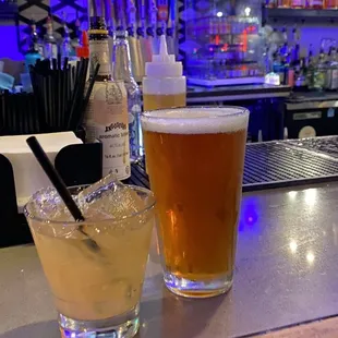 two glasses of beer on a bar